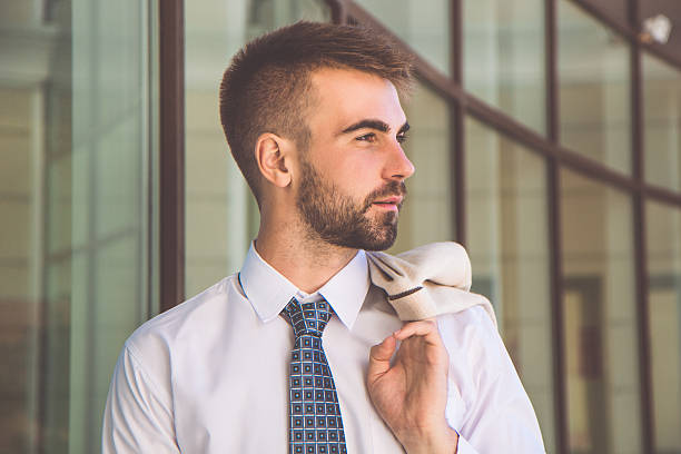 istock Businessman with beard near office building 610259142