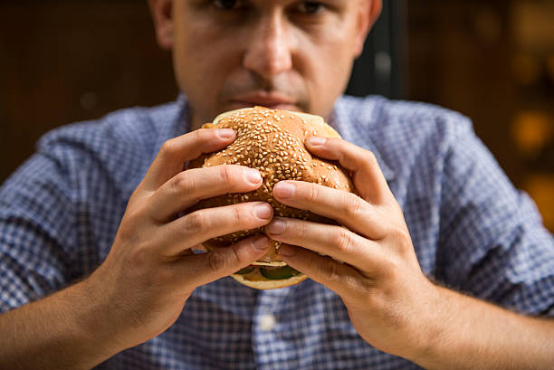 istock Man holding a big hamburger 610260858
