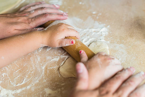 istock Children and dad hands rolled dough 610261790