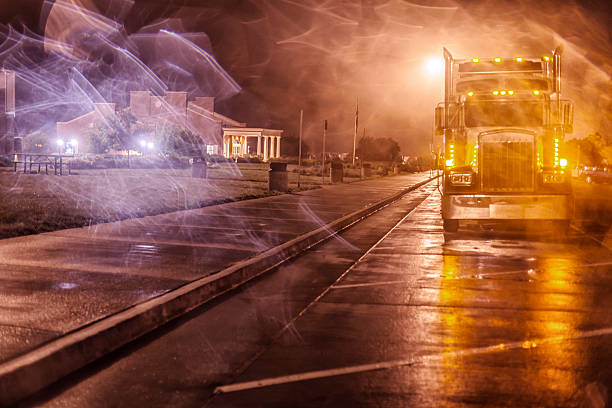 Nighttime Expressway Rest Stop Ghostly Semi Trailer Truck Abstract windy, foggy, swirly, ghostly street light reflections through a murky car window in a nighttime expressway rest stop parking lot - looking at a semi-trailer truck parked for the night. truck in rain stock pictures, royalty-free photos & images