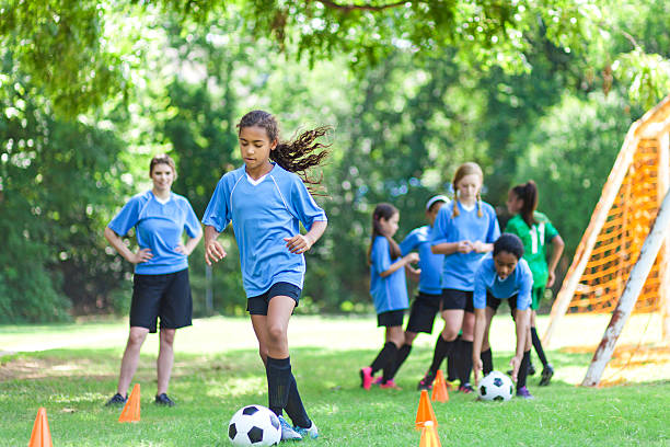 istock Talented soccer player kicks ball around practice cones 610263630