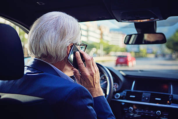 istock Businessman is talking using his mobile phone in the car 610264474