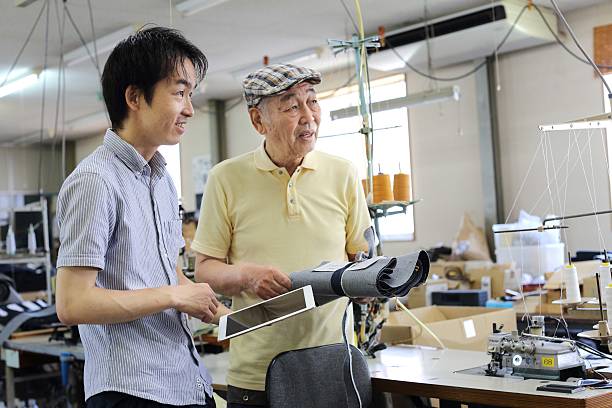 istock Senior tailors who make a design with a digital tablet 610409124