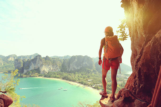 istock young woman backpacker hiking on seaside 610410082