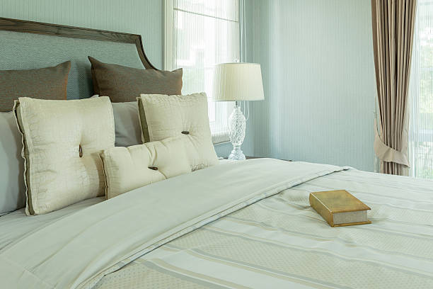 istock bedroom interior with white pillows and reading lamp on bed 610411686