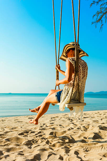 istock Woman at tropical swing 610412522