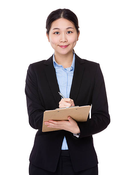 istock Businesswoman writing on clipboard 610412954