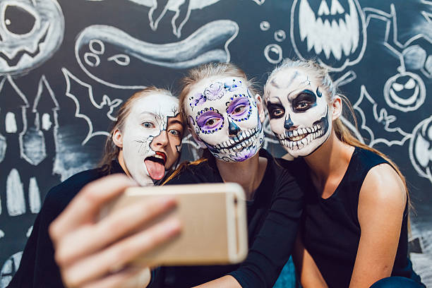 istock Three girls going on Halloween, grimace make selfie  a dark 610413870