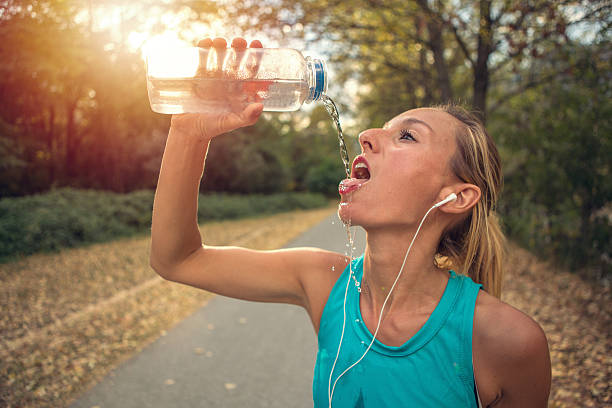 istock Woman runner drinking from water bottle 610413902