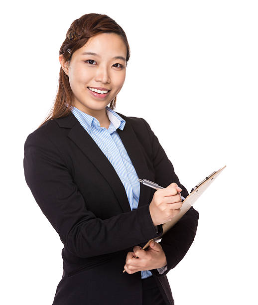 istock Businesswoman writing on clipboard 610414486