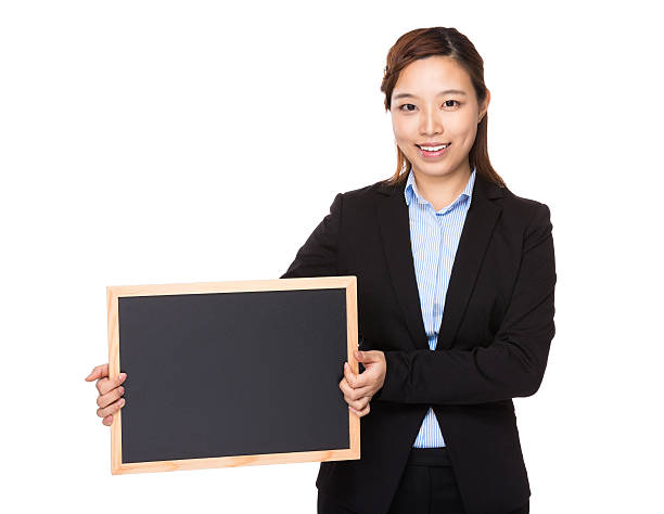 istock Businesswoman holding chalkboard 610414896