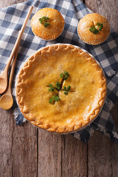 istock American Chicken pot pie on the table. vertical top view 610417410