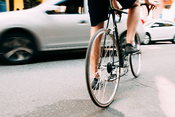 istock Man start riding on bicycle in city 610417720