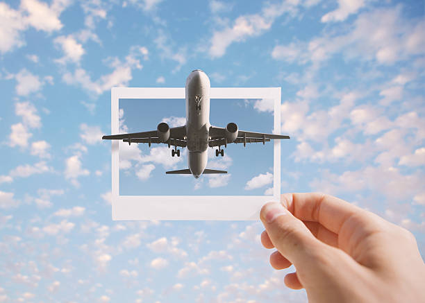 Holding instant photo Airplane flying out the instant photo. Toned image. air vehicle photos stock pictures, royalty-free photos & images