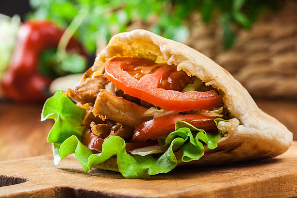 Doner kebab - fried chicken meat with vegetables Doner kebab - fried chicken meat with vegetables in pita bread pita bread stock pictures, royalty-free photos & images