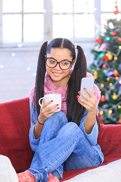 istock Woman sitting on couch and making selfie at home 610418752