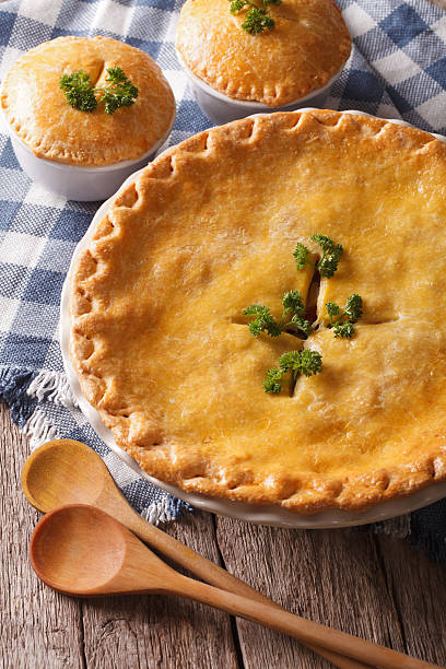 istock Golden Chicken pot pie in the baking dish closeup. vertical 610419554
