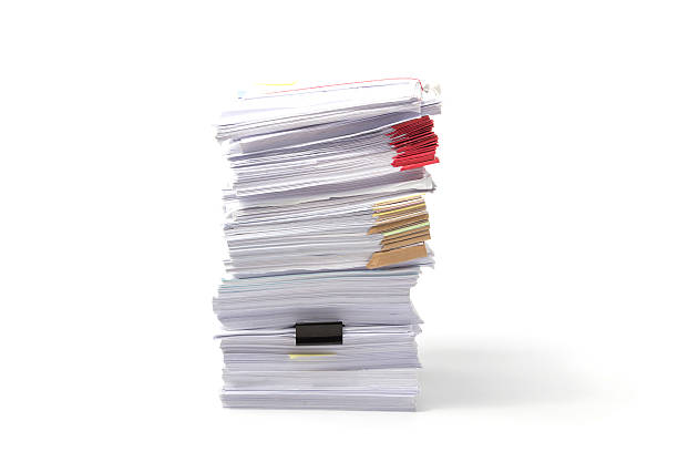 istock Stack of business papers isolated on white background 610420744