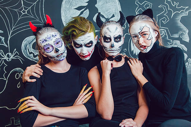 istock Three girls and a guy with Halloween face art on 610421648