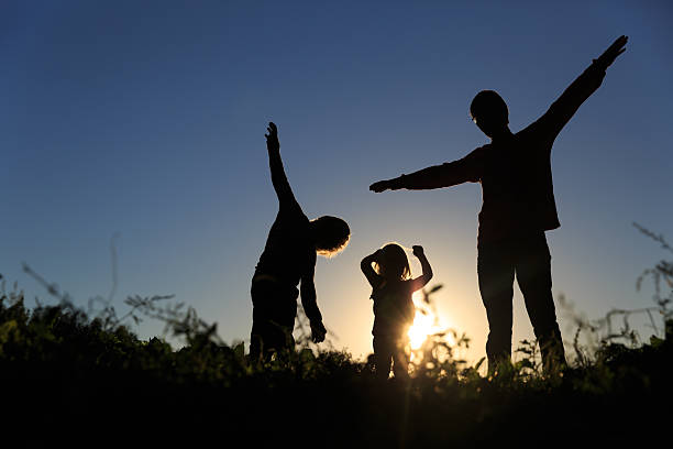 istock happy father with son and daughter play at sunset 610423318