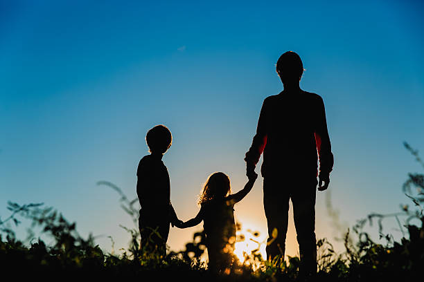 istock father with son and daughter walk at sunset 610423476