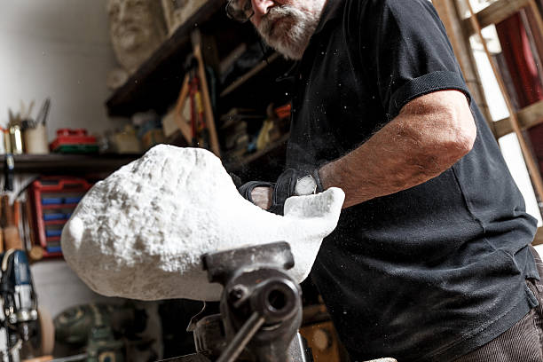 istock Senior sculptor working on his sculpture 610425048