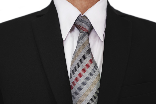 Close-up of businessman wearing black suit with a gray tie, white shirt