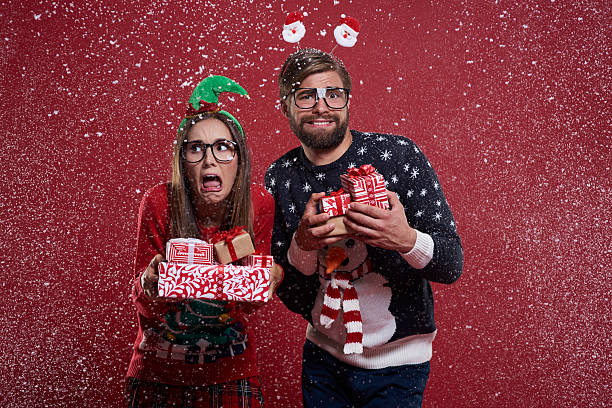 istock Couple with presents standing in the snow 610425438