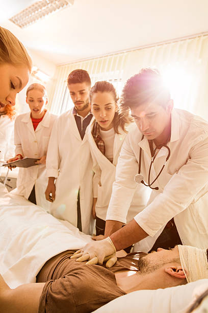 istock Doctor performing CPR on patient while his colleagues are watching. 610425680