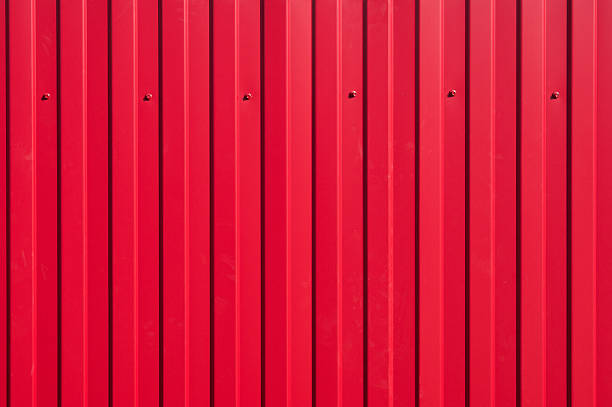 istock Iron fence with bright red ribs and cogs 610426106