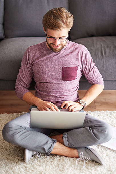 istock Fashionable man using contemporary laptop at home 610426198