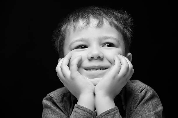 istock portrait of a boy on a dark background 610426620