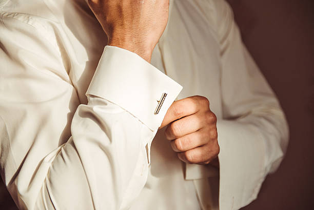 istock man in neat white shirt fixing cufflinks carefully 610426940