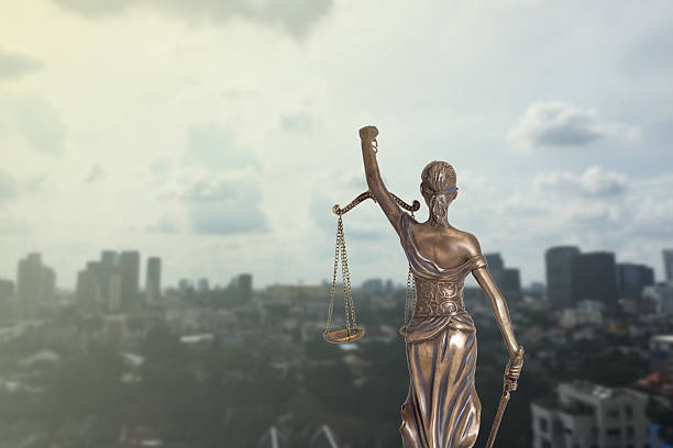 istock Lady Justice and city view 610428624