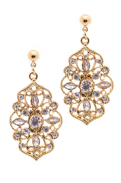 istock Gold earrings inlaid with precious stones on a white background 610429672