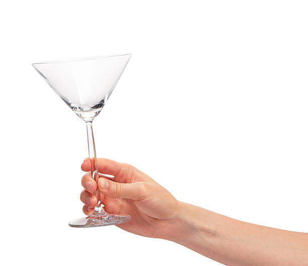 istock Female hand holding empty clean transparent martini glass 610431828