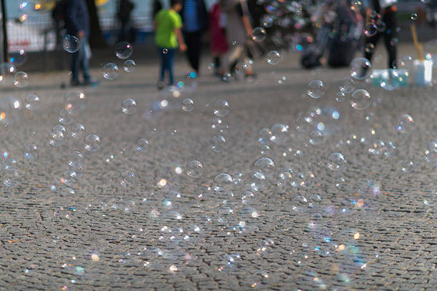 istock soap bubbles flying in front of street 610431950