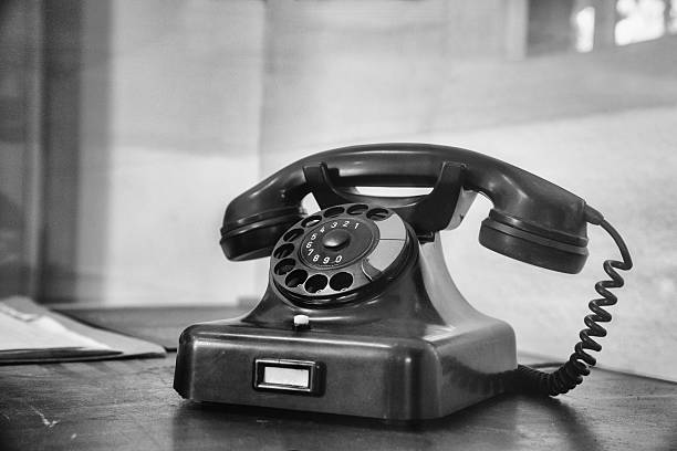 istock vintage telephone with dial plate on old desk 610432498