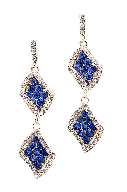istock Gold earrings inlaid with  gemstones on a white background 610432886