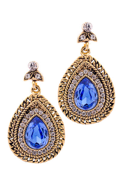 istock Gold earrings inlaid with  gemstones on a white background 610433258