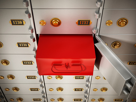 Mistery red box behind open metal safety deposit box