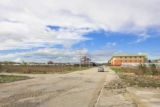 Turkish landscape near Kadrye village Kadrye, Turkey - January 6, 2015: Kadrye village between Antalya and Belek towns. Car on the road and small buildings. Turkey. Asia Minor belek town stock pictures, royalty-free photos & images
