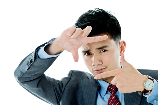 Young asian businessman making frame with his hands.