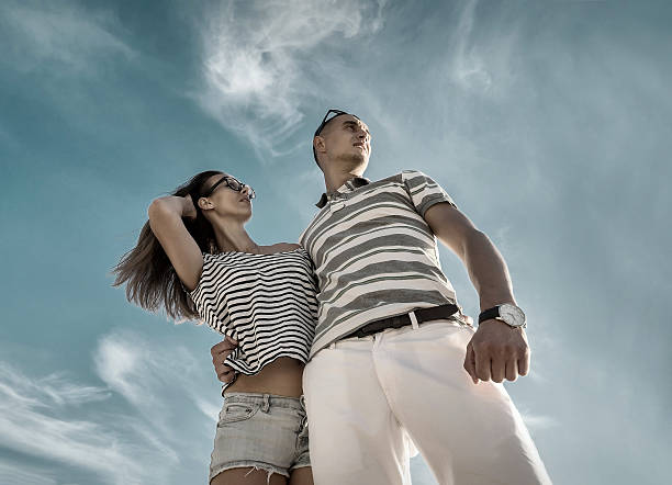 istock Couple stay on the beach under sky with sunlight. 610434930