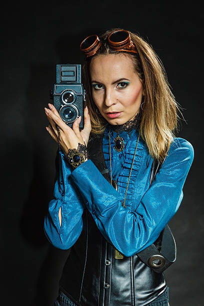istock Woman with camera in style steampunk 610435050