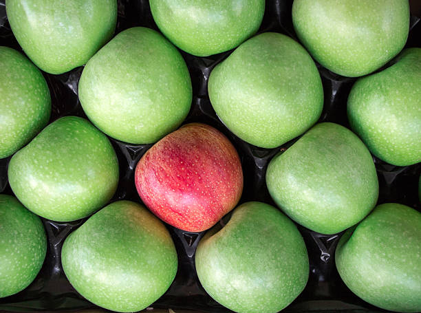 istock Unique. Red apple among a group of green apples. 610435482