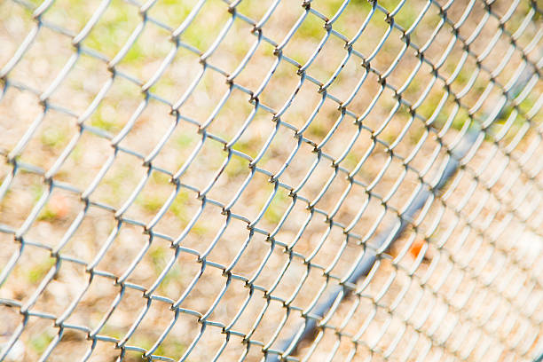 istock steel wire mesh fence. 610435544