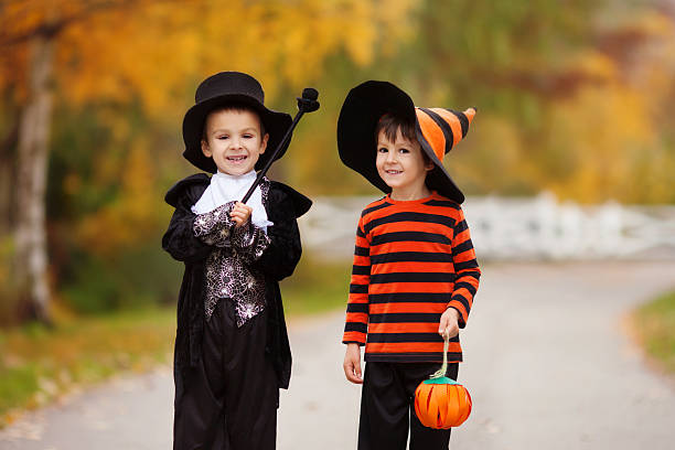 istock Two boys in the park with Halloween costumes 610437132