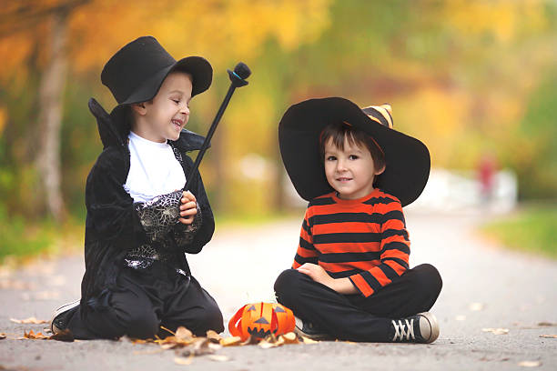 istock Two boys in the park with Halloween costumes 610437178