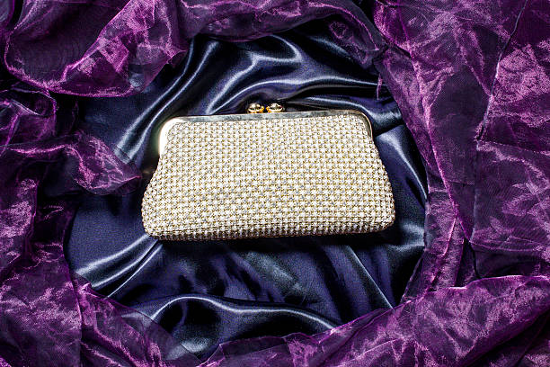 istock white clutch inlaid diamonds on silk background 610437554